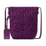 Purple crossbody bag with floral quilting and a matching luggage tag displaying a brand logo.