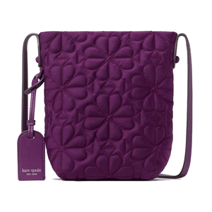 Purple crossbody bag with floral quilting and a matching luggage tag displaying a brand logo.