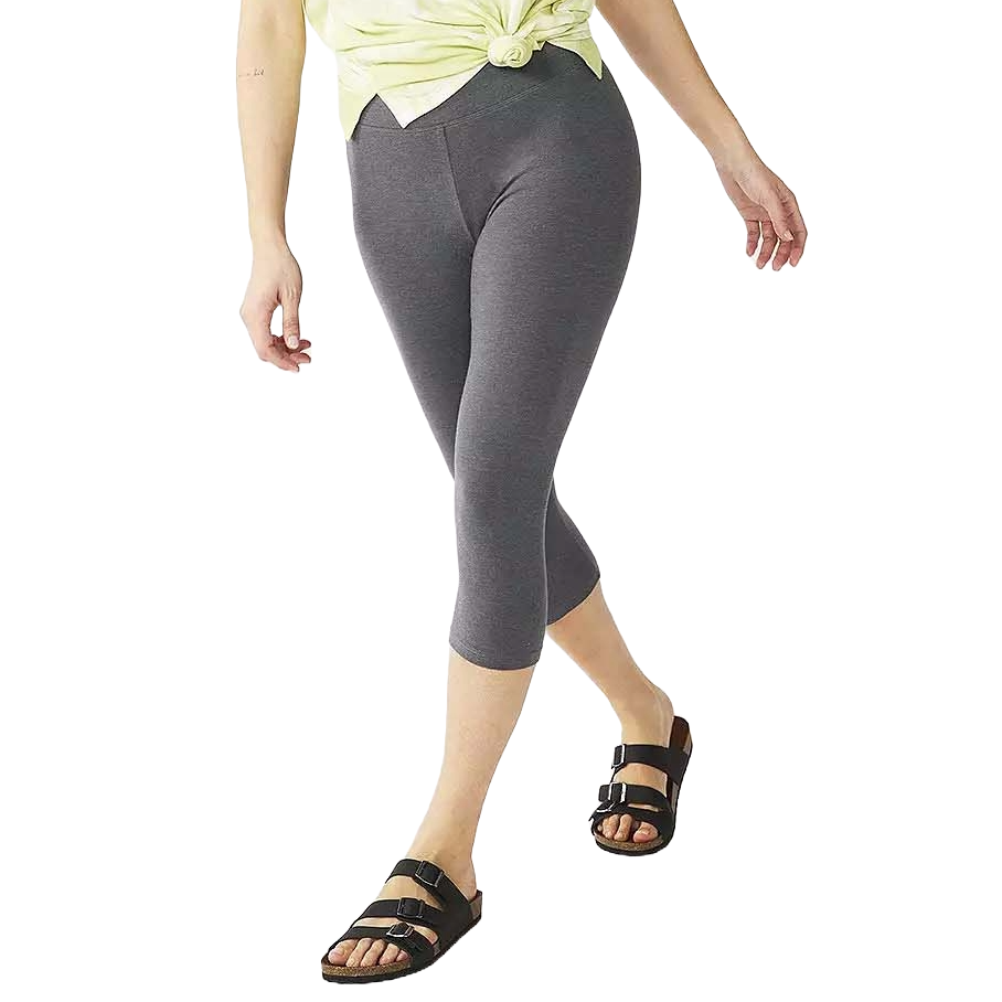 A person wearing grey cropped leggings paired with black two-strap sandals and a light yellow knotted top.