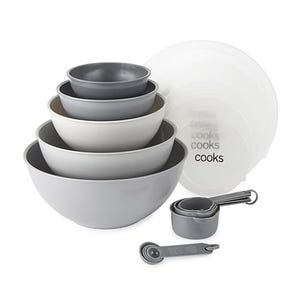 A set of stackable mixing bowls and measuring cups in varying shades of gray.