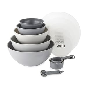 A set of stackable mixing bowls and measuring cups in varying shades of gray.