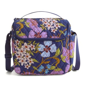 A quilted shoulder bag with floral patterns in blue, purple, white, and pink, featuring a top handle and adjustable strap.