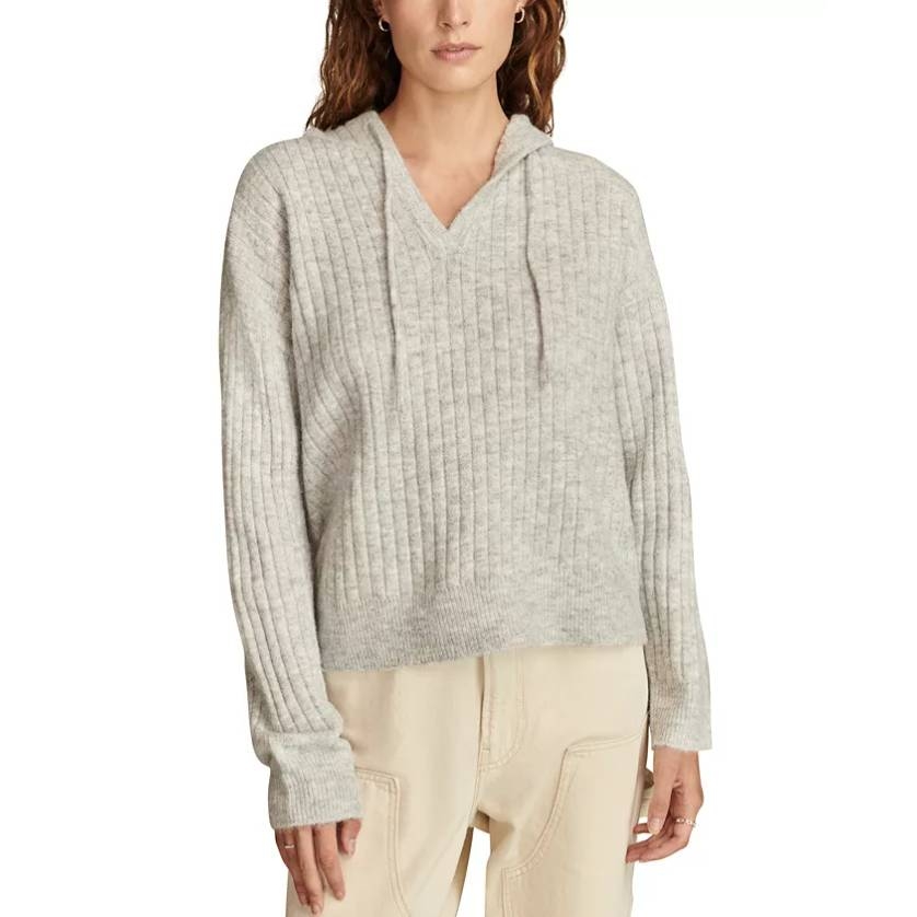Light gray, ribbed hooded sweater with a V-neck and drawstrings, paired with cream-colored pants.