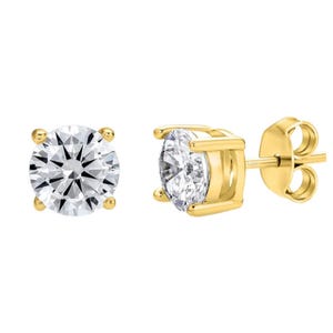 Round-cut diamond solitaire earrings set in four-prong yellow gold settings with push-back closures.