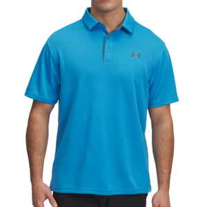 A man is wearing a blue Under Armour polo shirt with a small logo on the chest, featuring a button-up collar and short sleeves.