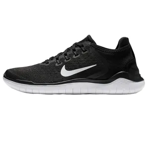 Nike Free Run 2018 shoes feature a black mesh upper with a prominent white Swoosh logo, offering flexibility and lightweight comfort. They have a rounded lace system and a white cushioned sole for enhanced natural movement.