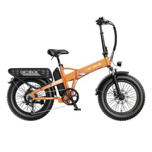 An orange electric bike with a foldable frame, fat tires, rear rack, and visible battery pack. It features a headlight and fenders designed for various terrains and practical use.