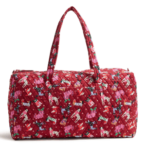 Vera Bradley Large Duffel in a vibrant red with a quilted design featuring whimsical dogs and holiday motifs, has sturdy handles for easy carrying.