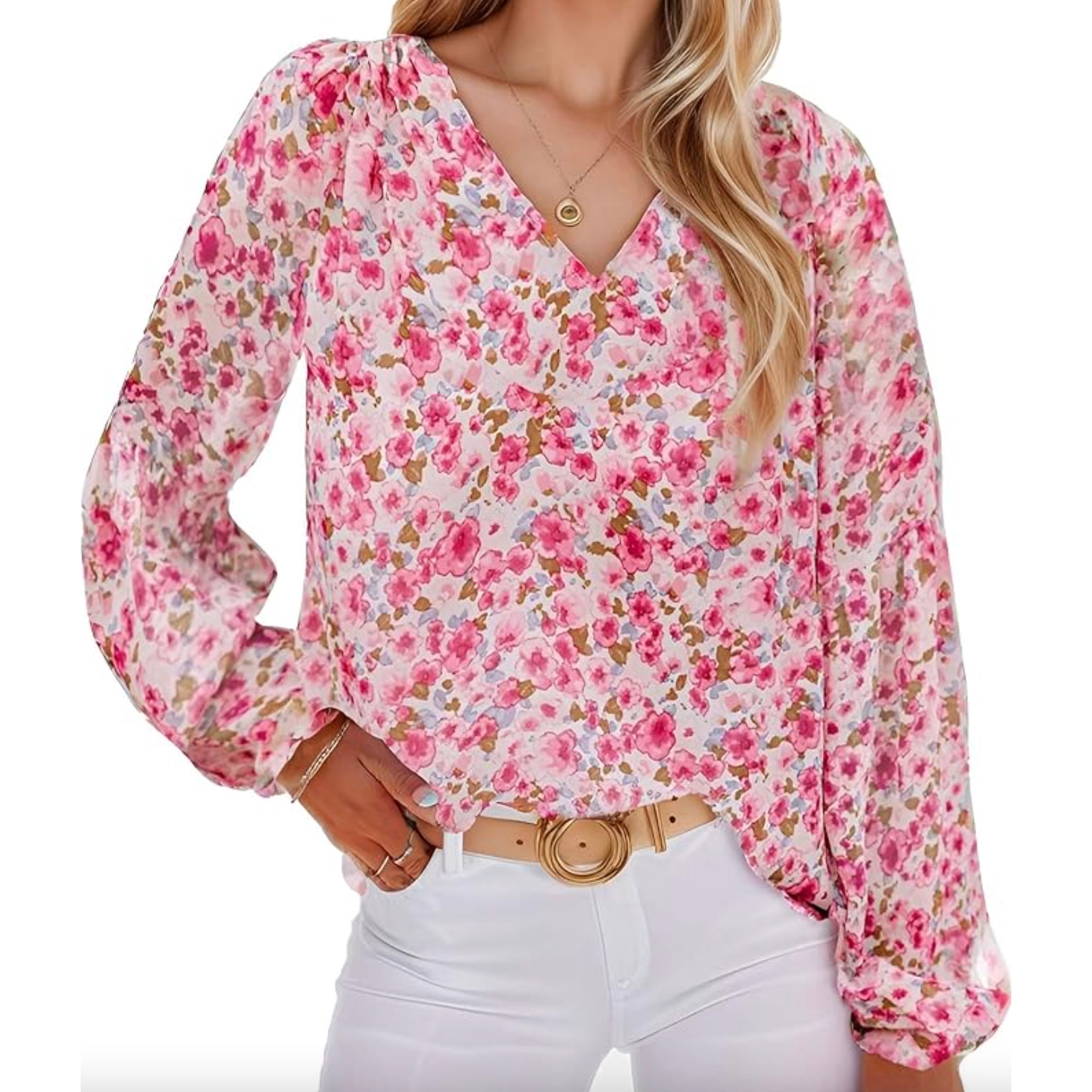 Women's floral blouse with a pink and white floral pattern, V-neck, and long sleeves. Paired with a tan belt and white pants, featuring a flowy, relaxed fit.