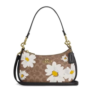 A shoulder bag with Coach's signature monogram print, adorned with large white daisy floral motifs and a black leather bottom. It features a gold-tone chain strap and a leather Coach tag.