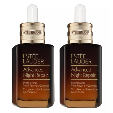 Two bottles of Estée Lauder Advanced Night Repair Synchronized Multi-Recovery Complex with droppers, gold caps, and a dark amber gradient design.