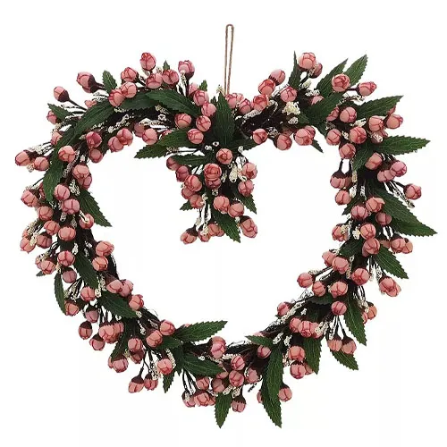 Heart-shaped wreath adorned with pink rosebuds and green leaves, featuring a central cluster for added decoration.