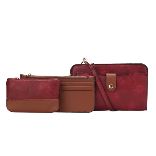 A set of three items including a red and brown crossbody bag, a matching small pouch, and a cardholder with a snap button and multiple slots.