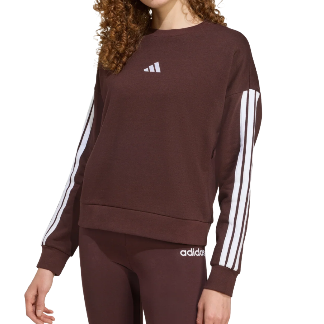 A brown Adidas sweatshirt with a white logo on the chest and white stripes down the sleeves, paired with matching brown leggings featuring a small white Adidas logo.