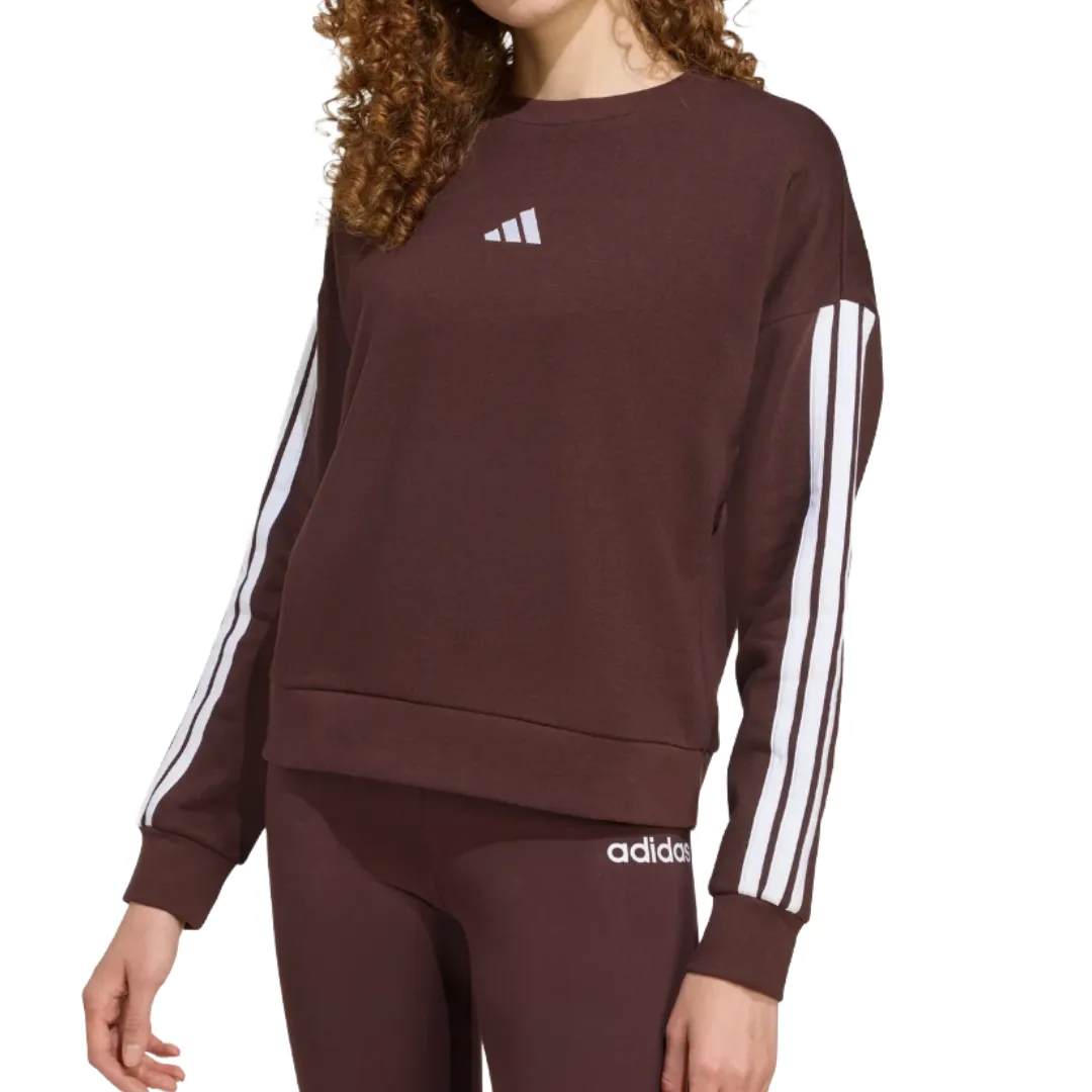 A brown Adidas sweatshirt with a white logo on the chest and white stripes down the sleeves, paired with matching brown leggings featuring a small white Adidas logo.