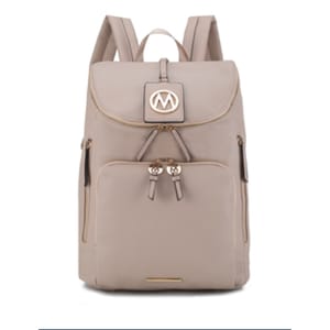 A beige backpack with 10 pockets, featuring a flap top, adjustable straps, and gold-tone zippers. There's a distinct \“M\“ logo on the front flap, adding a stylish touch.