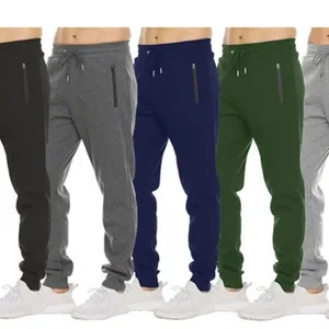 Five pairs of jogger pants in black, gray, navy, green, and light gray, each featuring zippered side pockets and paired with white sneakers.