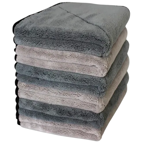 A stack of six gray and beige folded towels with soft, plush texture.