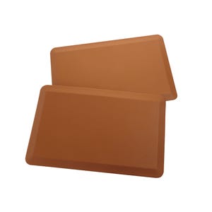 Two brown silicone baking mats on a white background.