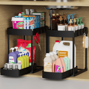 A compact shelving unit under a sink holds various cleaning products, including detergents, fabric softeners, soaps, and disinfectant wipes, organized neatly with a pair of scissors and a brush hanging on the sides.