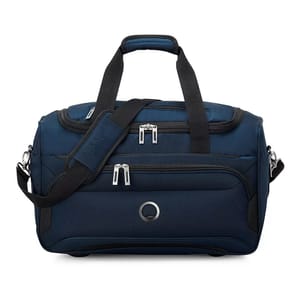 A navy blue Delsey Paris duffle bag with black accents, featuring dual handles, an adjustable shoulder strap, and multiple zippered compartments for storage.