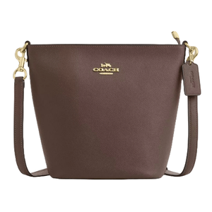 Brown Coach bucket bag with gold hardware and detachable strap, featuring the Coach logo on the front and a leather tag.