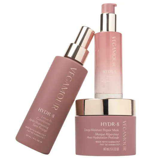VEGAMOUR HYDR-8 hair care items, including a Leave-In Conditioner, Deep Moisture Repair Mask, and Weightless Hair Serum, feature Karmatin and come in pink bottles.