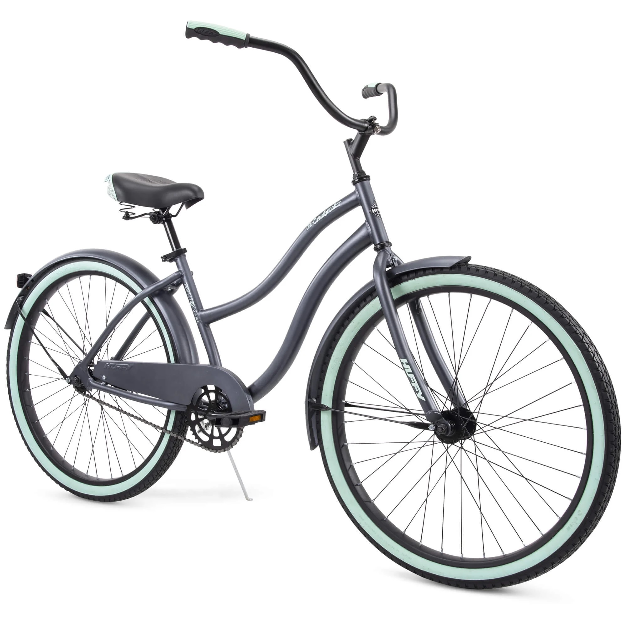 A cruiser bicycle with a step-through frame, featuring a dark gray finish, light mint-colored tires, a black seat, and swept-back handlebars.
