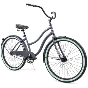 A cruiser bicycle with a step-through frame, featuring a dark gray finish, light mint-colored tires, a black seat, and swept-back handlebars.