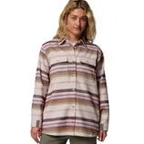 A person wearing a long-sleeve, button-up shirt with horizontal stripes in pink, brown, and beige tones, featuring chest pockets.