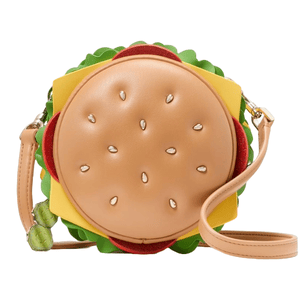 A handbag designed to resemble a hamburger, featuring a circular tan bun with sesame seed details, layers of colorful faux lettuce, tomato, and cheese, and a detachable strap.