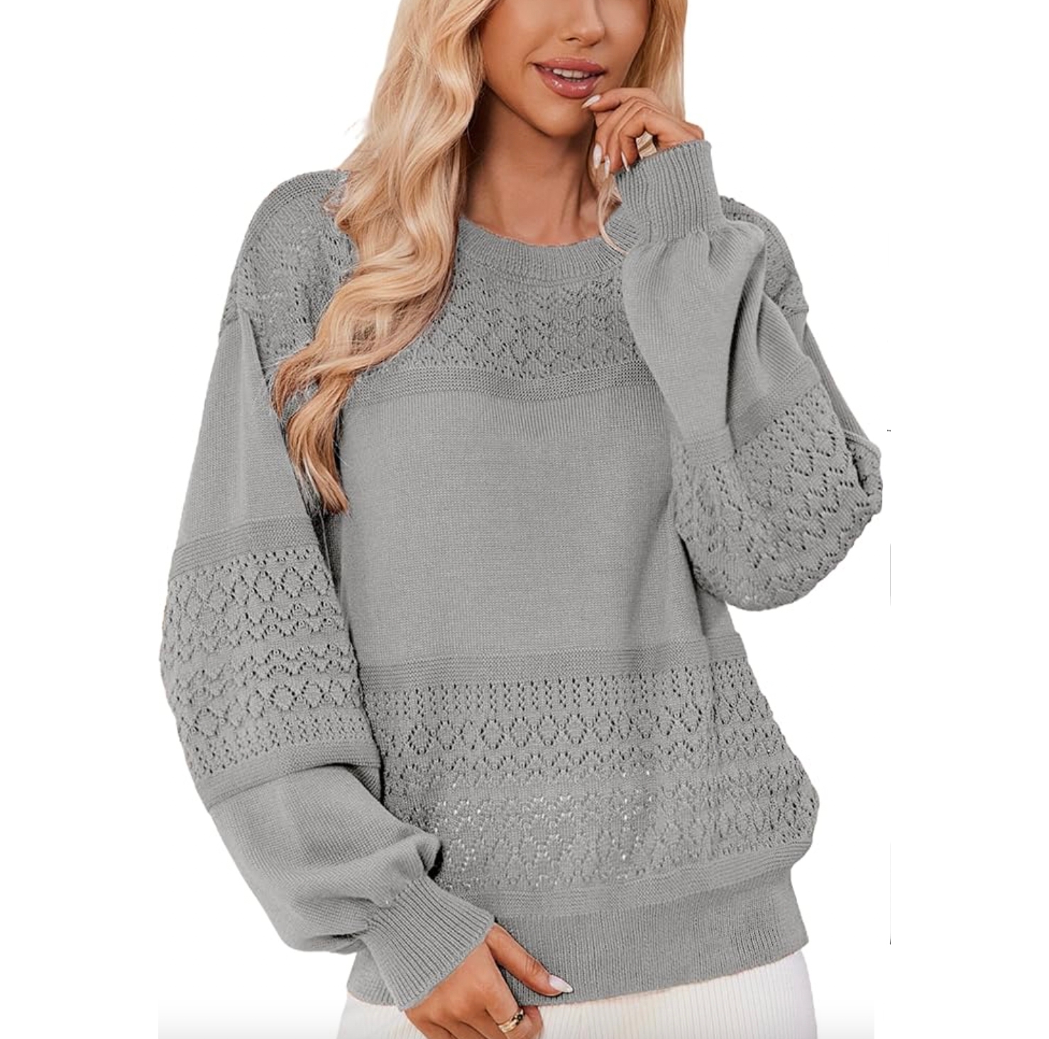 A gray knit sweater features intricate lace patterns on the yoke and sleeves, with a relaxed fit and ribbed cuffs and hem.