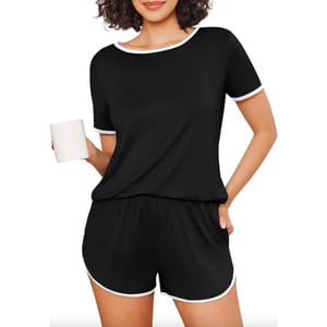 Black short-sleeve pajamas with white trim and pockets, featuring a relaxed fit and matching shorts.