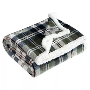 Eddie Bauer Faux-Shearling Throw features a green, white, and brown plaid pattern with a soft, fluffy white faux-shearling lining.