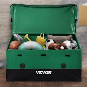 A green storage box filled with various sports and outdoor items, including a basketball, a soccer ball, a baseball glove, rollerblades, a watering can, a cushion, and a swim ring.