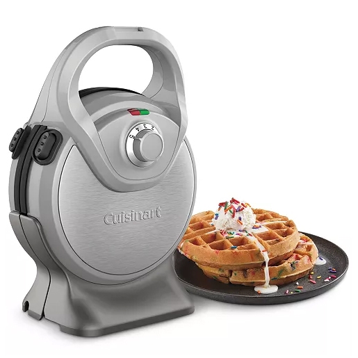 A Cuisinart 2-in-1 waffle maker with a silver, vertical design and a rotary dial, accompanied by a plate of golden-brown waffles.
