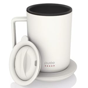 White mug with a lid and matching coaster, featuring the brand \“purée\“ on the front.