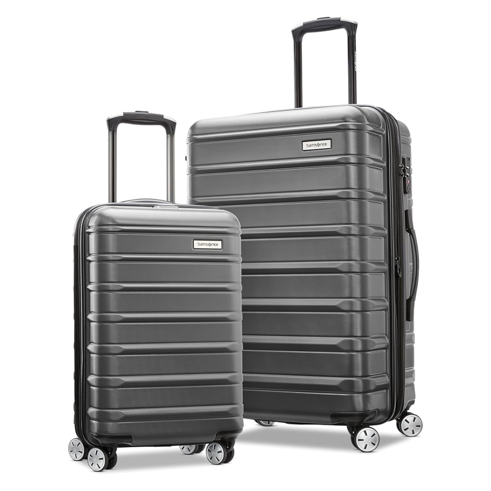 Two hard-shell suitcases with telescopic handles and four spinner wheels, featuring a ribbed design. They are gray and come in different sizes, suitable for travel.