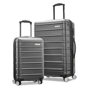 Two hard-shell suitcases with telescopic handles and four spinner wheels, featuring a ribbed design. They are gray and come in different sizes, suitable for travel.
