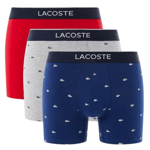 Set of three Lacoste men's boxer briefs featuring solid red and gray pairs, and a navy pair with a small crocodile logo pattern.