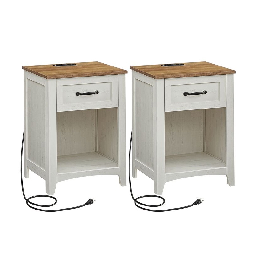 Set of two white nightstands with contrasting wood tops, each featuring a drawer, an open shelf, and built-in charging ports with power cords.