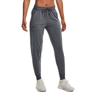Gray joggers with an elastic waistband and ankle cuffs, featuring a drawstring and small logo on the left thigh. Paired with white athletic shoes.