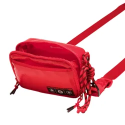 A red crossbody bag with adjustable strap, two compartments with zippers, and a decorative braided cord detail.