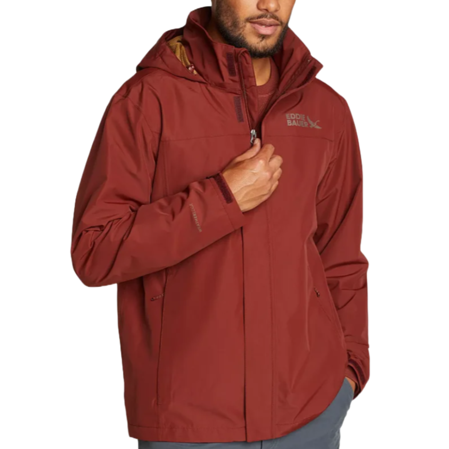 The Eddie Bauer Rainfoil Jacket is a maroon waterproof jacket with a hood, featuring a full front zipper and two side pockets. It's designed for outdoor use and provides protection against rain.