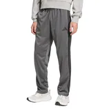 Gray athletic track pants with a three-stripe design and brand logo, paired with white sneakers and a gray sweatshirt.
