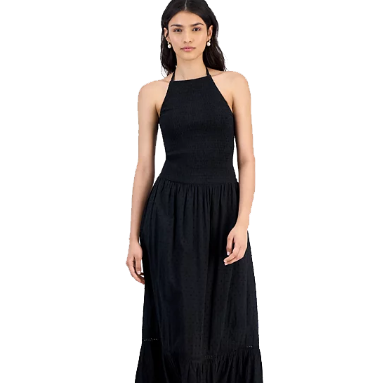 A woman wearing a black halter-neck midi dress with a fitted bodice and flared skirt.