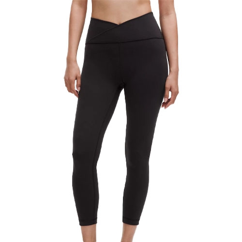 Black leggings featuring a high-rise, cross-waist design, offering a stylish and secure fit, ending just above the ankle.