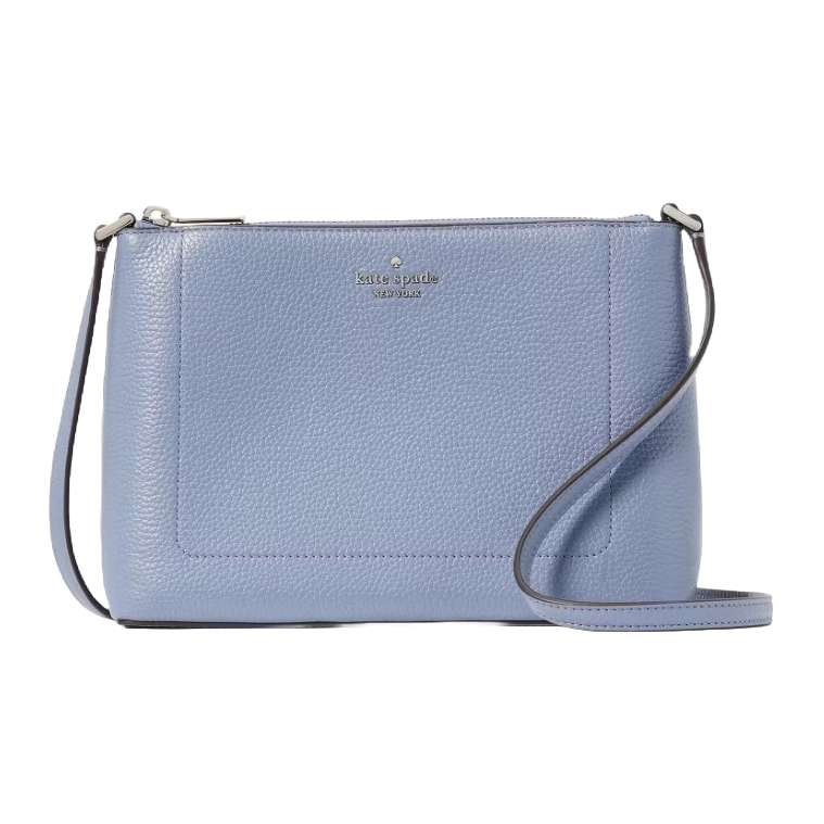 A light blue leather Kate Spade crossbody bag features a pebbled texture, a slim design, and a long adjustable strap, complemented by a small printed logo on the front.