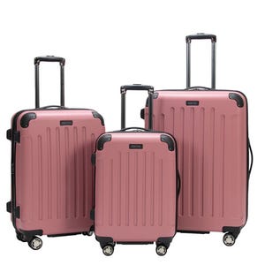 A 3-piece Kenneth Cole luggage set in rose color with hardshell exteriors, spinner wheels, and telescopic handles. The set includes three suitcases of graduated sizes for different travel needs.