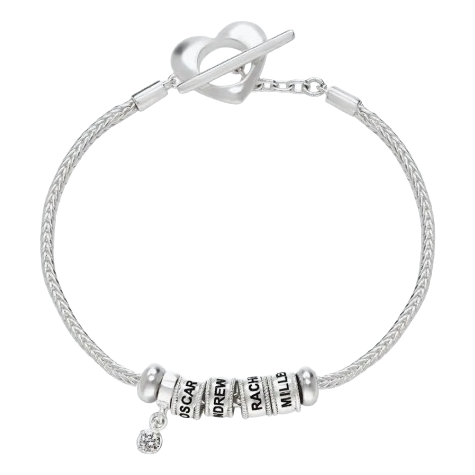 A silver bracelet features a heart-shaped clasp and three engraved beads with personalized names, alongside a charm with a small gemstone.